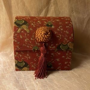 Small jewelry box w/elephant fabric. Trunk shaped burgundy colored w/tray
